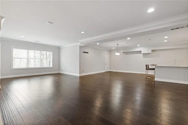 a view of an empty room with wooden cabinet