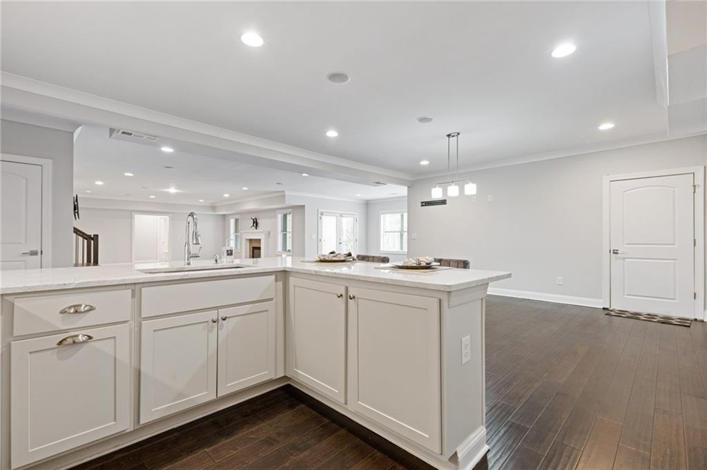 1560 Tapestry Ridge Southeast Lawrenceville, GA 30045 - Photo 44 of 57 a open kitchen with kitchen island white cabinets and white appliances