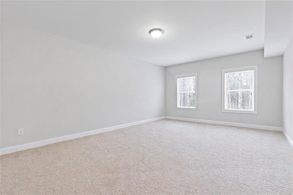 1560 Tapestry Ridge Southeast Lawrenceville, GA 30045 - Photo 51 of 57 an empty room with windows