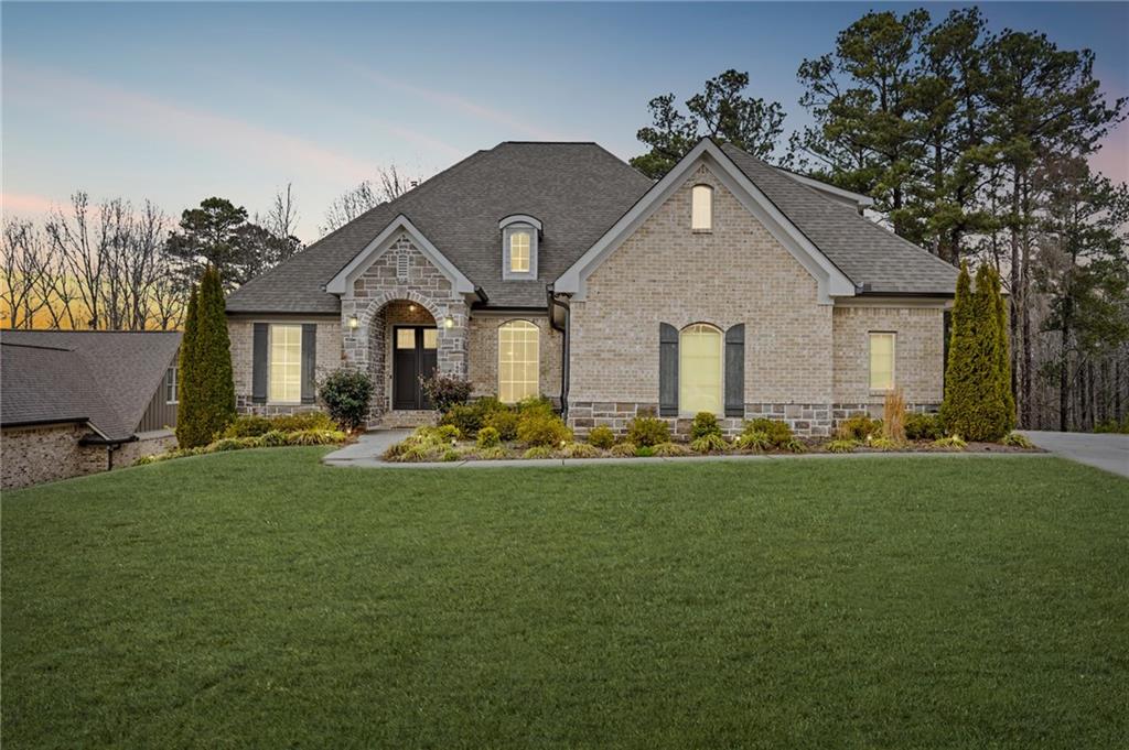 1560 Tapestry Ridge Southeast Lawrenceville, GA 30045 - Photo 57 of 57 a front view of a house with backyard garden and outdoor seating