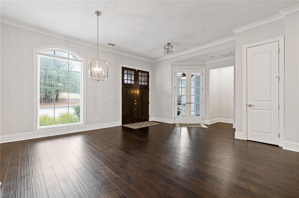 1560 Tapestry Ridge Southeast Lawrenceville, GA 30045 - Photo 9 of 57 a view of an empty room with wooden floor and a window