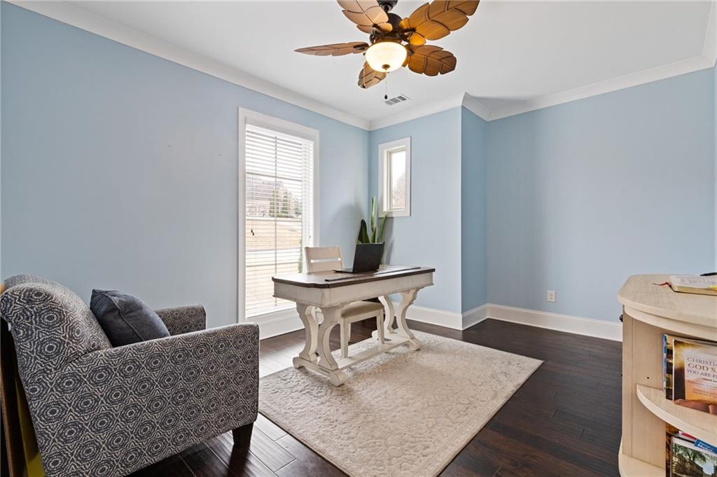 1560 Tapestry Ridge Southeast Lawrenceville, GA 30045 - Photo 10 of 57 a living room with furniture a wooden floor and a chandelier