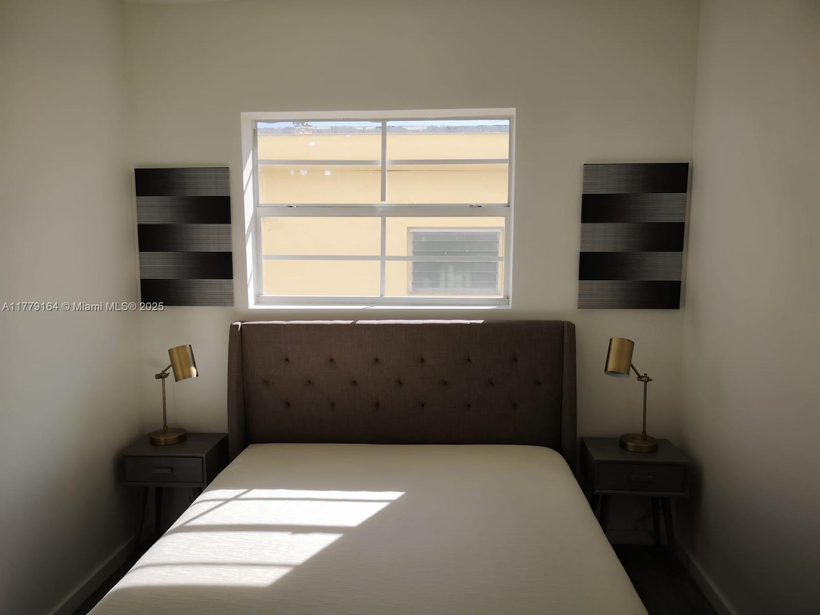 810 7th Street, Unit 203 Miami Beach, FL 33139 - Photo 6 of 7 a room with a bed and a window