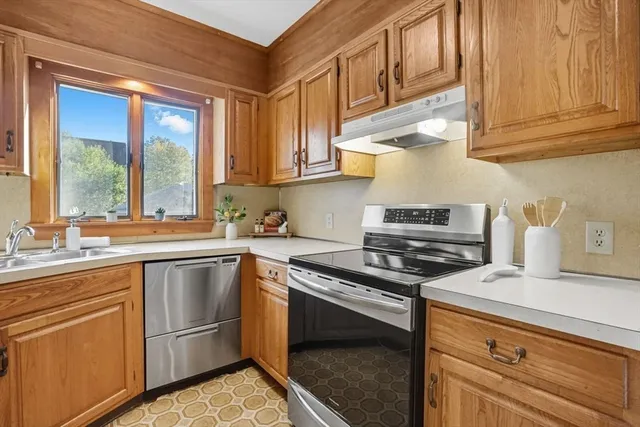 a kitchen with stainless steel appliances granite countertop a stove and a sink