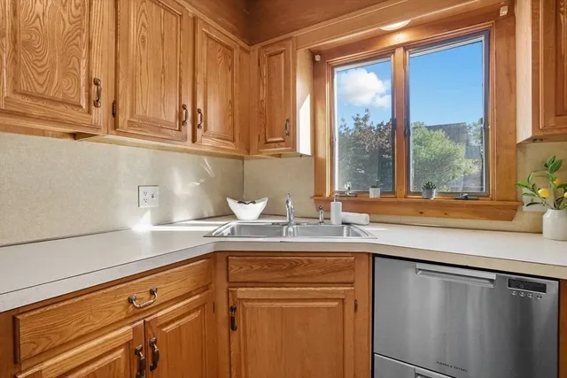 a kitchen with stainless steel appliances granite countertop a sink and a cabinets