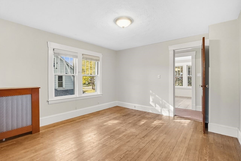 15 Bronson Terrace Springfield, MA 01108 - Photo 23 of 42 a view of an empty room with wooden floor and a window
