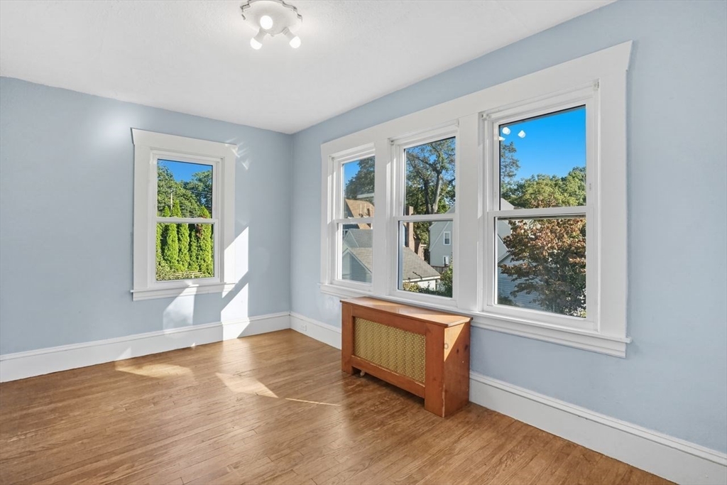 15 Bronson Terrace Springfield, MA 01108 - Photo 25 of 42 a view of an empty room with wooden floor and a window