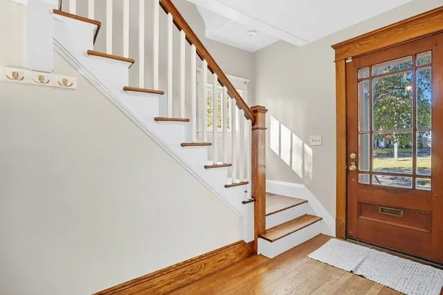 a view of entryway with wooden floor and stairs