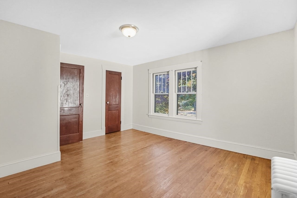 15 Bronson Terrace Springfield, MA 01108 - Photo 31 of 42 an empty room with wooden floor and windows