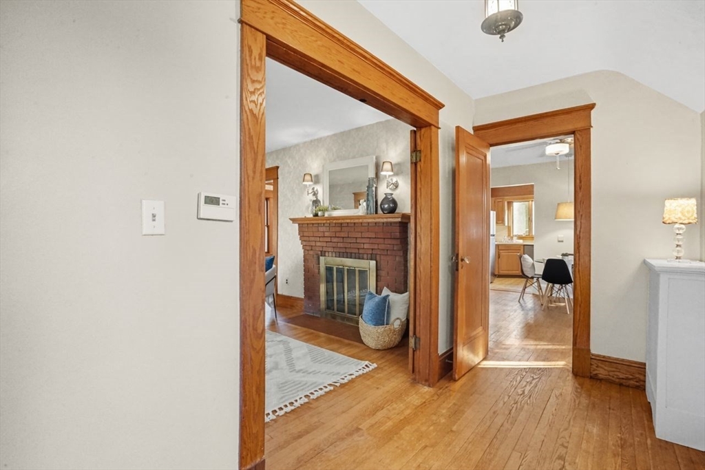 15 Bronson Terrace Springfield, MA 01108 - Photo 4 of 42 a view of a livingroom with wooden floor and a fireplace