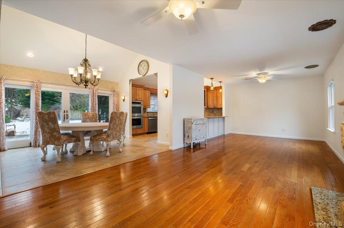 33 Fleets Cove Road Huntington, NY 11743 - Photo 15 of 42 Dining room with plenty of natural light, light wood-style floors, a ceiling fan, and vaulted ceiling