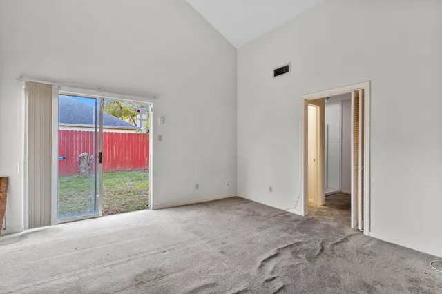 a view of an empty room and entryway