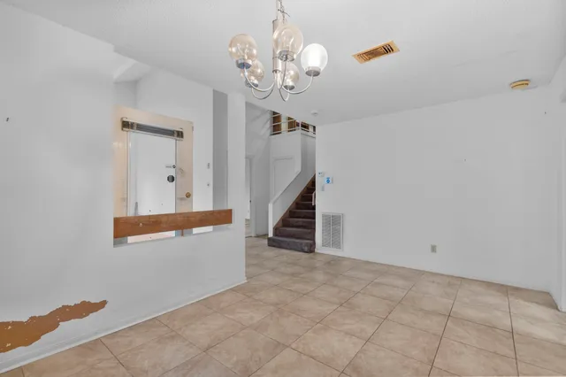 a view of a hallway with chandelier