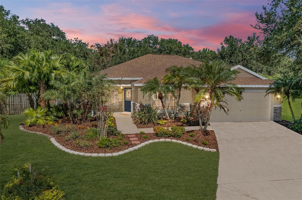a view of a house with backyard and sitting area