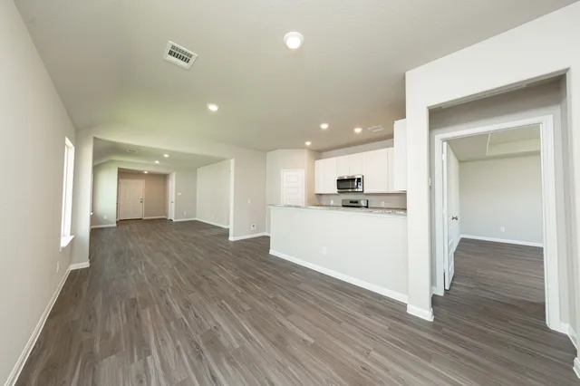 a view of a kitchen with wooden floor and a sink