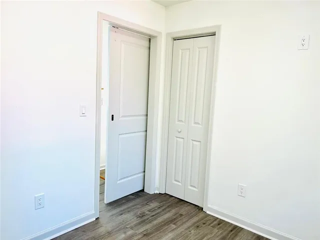 a view of an entryway with wooden floor
