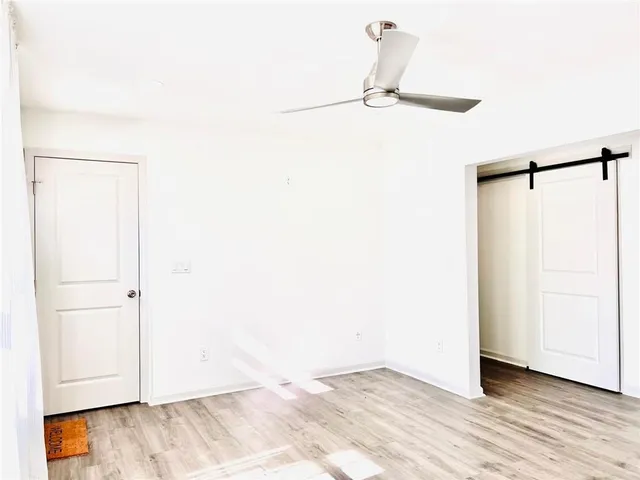 a view of a room with wooden floor