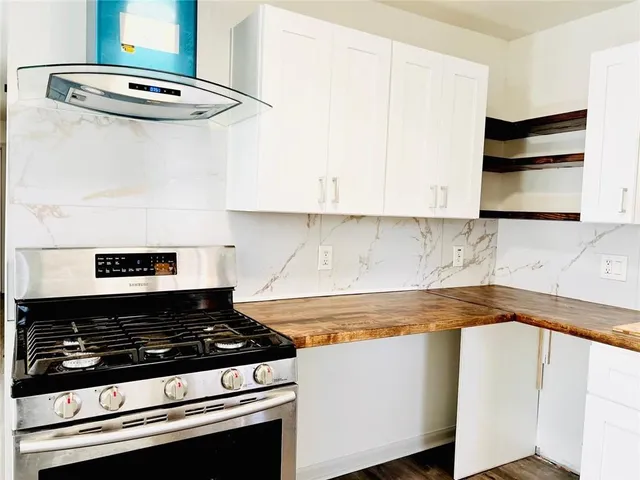 a stove top oven sitting inside of a kitchen
