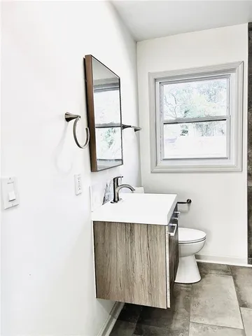 a bathroom with a sink toilet and mirror