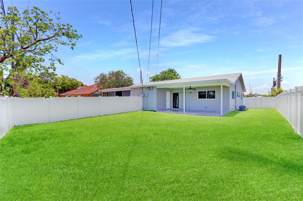 a view of a house with a backyard and a garden