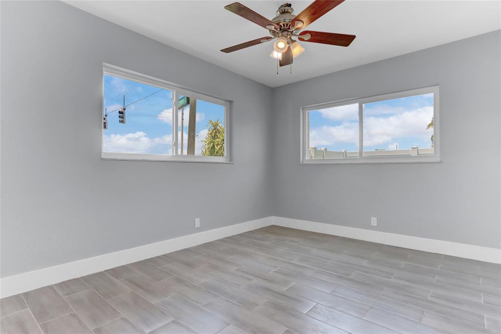 2822 North Dixie Highway Boca Raton, FL 33431 - Photo 13 of 22 a view of an empty room with a window and wooden floor