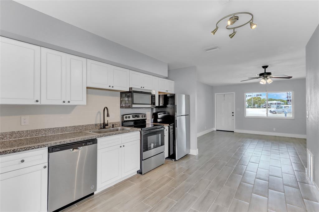 2822 North Dixie Highway Boca Raton, FL 33431 - Photo 6 of 22 a kitchen with granite countertop a sink cabinets and stainless steel appliances