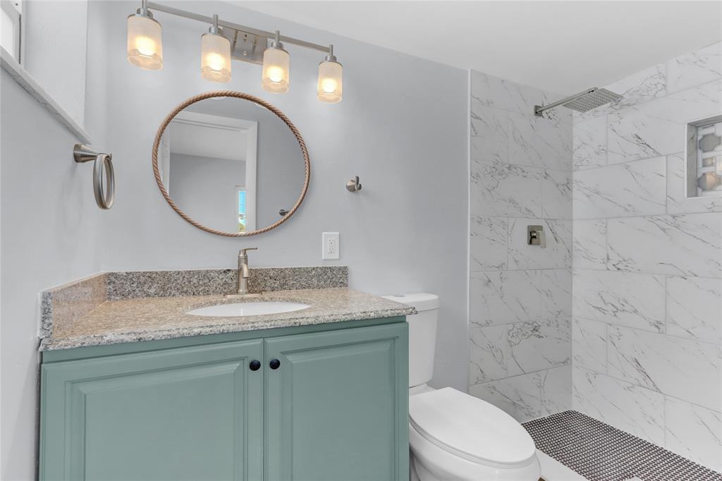 2822 North Dixie Highway Boca Raton, FL 33431 - Photo 7 of 22 a bathroom with a granite countertop toilet sink mirror and vanity