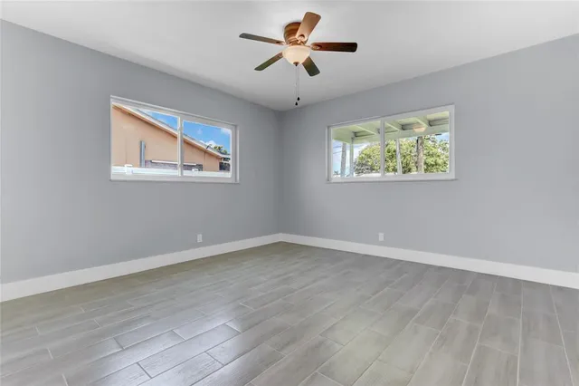 a view of room with window and ceiling fan