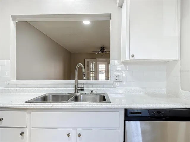a kitchen with stainless steel appliances granite countertop a sink and a stove