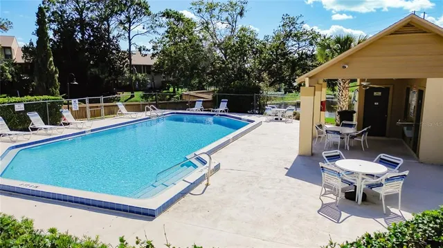 a swimming pool with outdoor seating yard and plants
