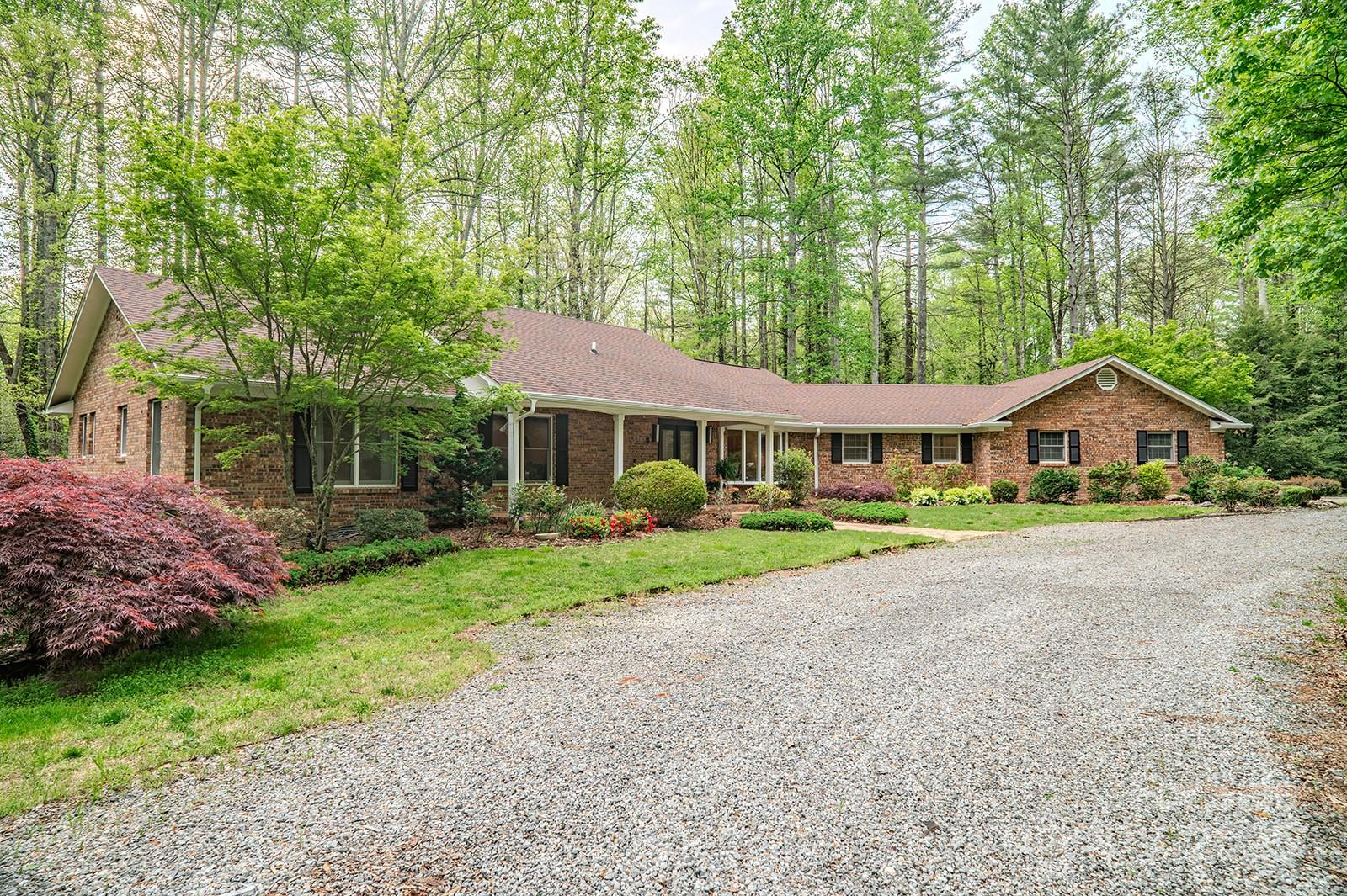 290 Tranquility Place Hendersonville, NC 28739 - Photo 1 of 48 a front view of a house with a yard and porch