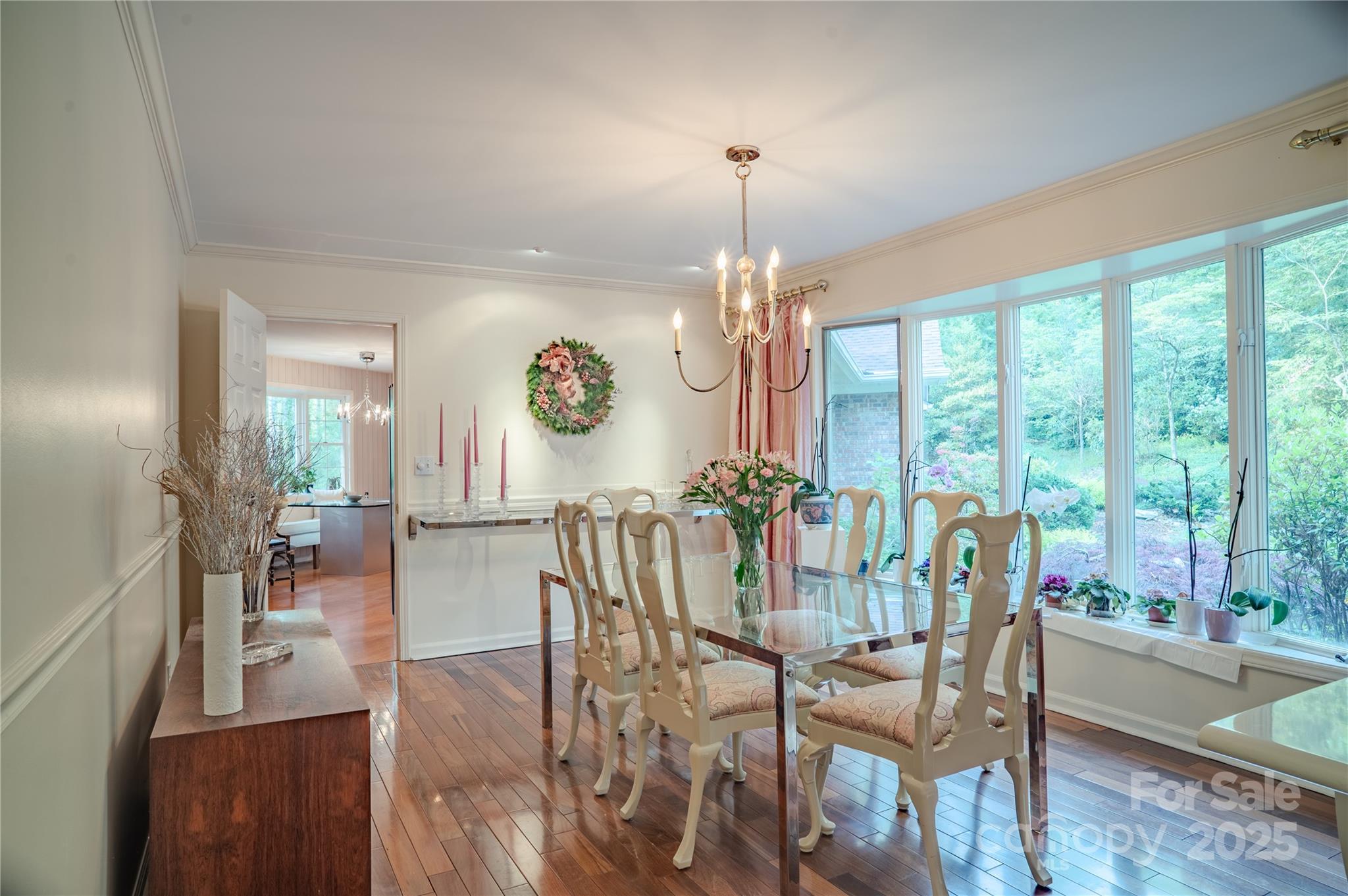 290 Tranquility Place Hendersonville, NC 28739 - Photo 14 of 48 a view of a dining room and livingroom with furniture wooden floor a chandelier