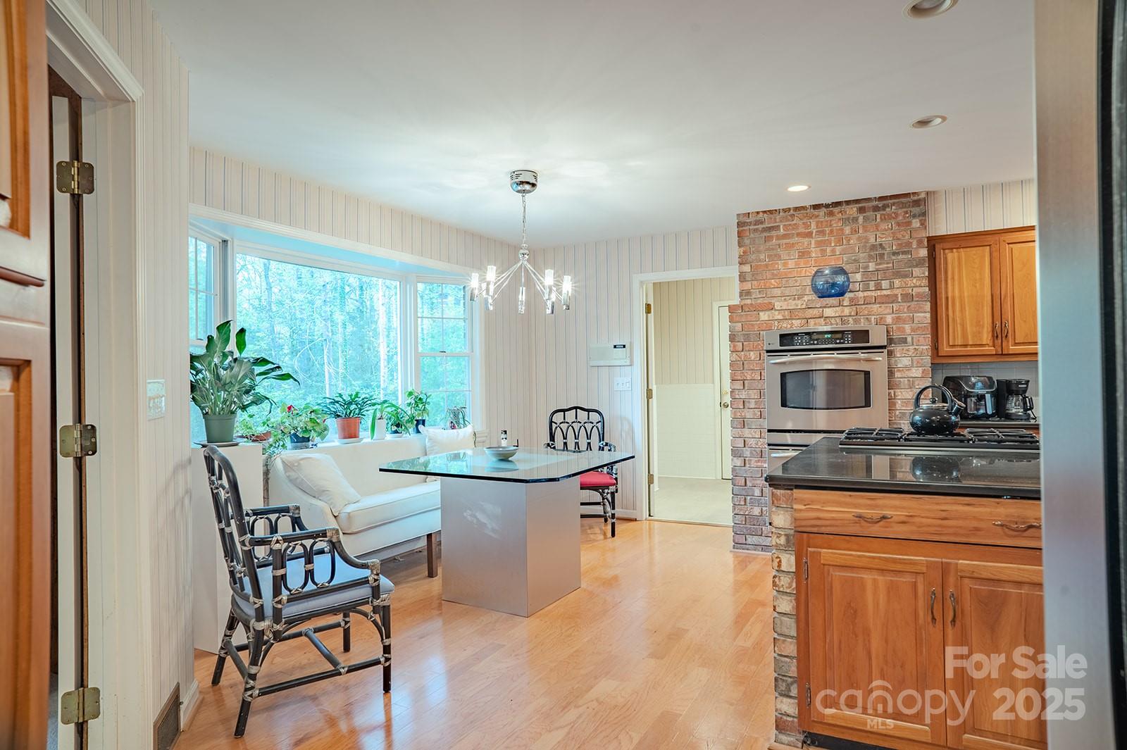 290 Tranquility Place Hendersonville, NC 28739 - Photo 16 of 48 a kitchen with a table and chairs