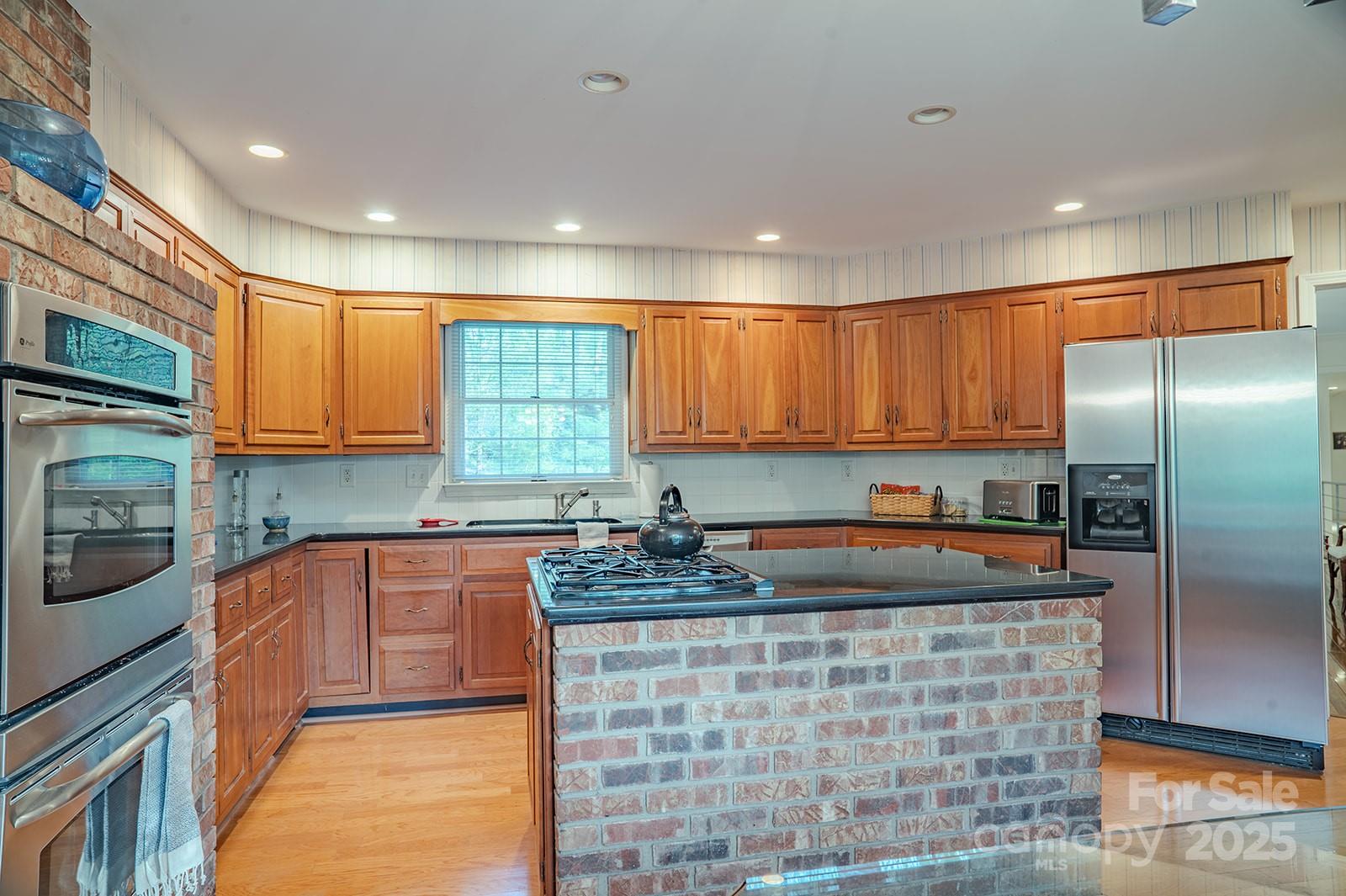 290 Tranquility Place Hendersonville, NC 28739 - Photo 18 of 48 a kitchen with stainless steel appliances granite countertop a sink stove and cabinets