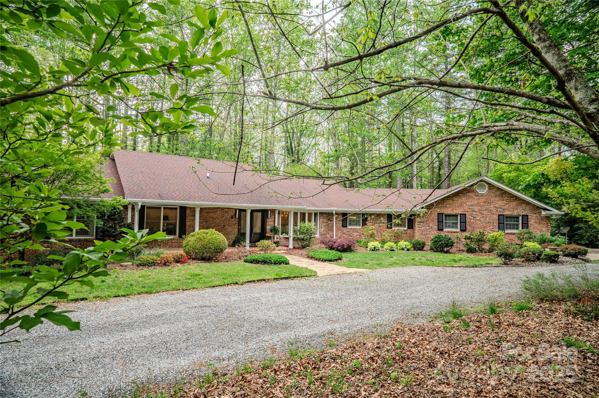 290 Tranquility Place Hendersonville, NC 28739 - Photo 2 of 48 a front view of a house with garden