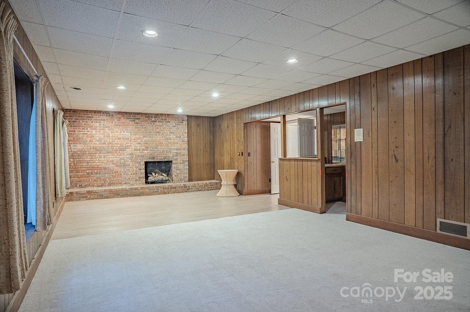 290 Tranquility Place Hendersonville, NC 28739 - Photo 39 of 48 a view of an empty room with furniture and a kitchen