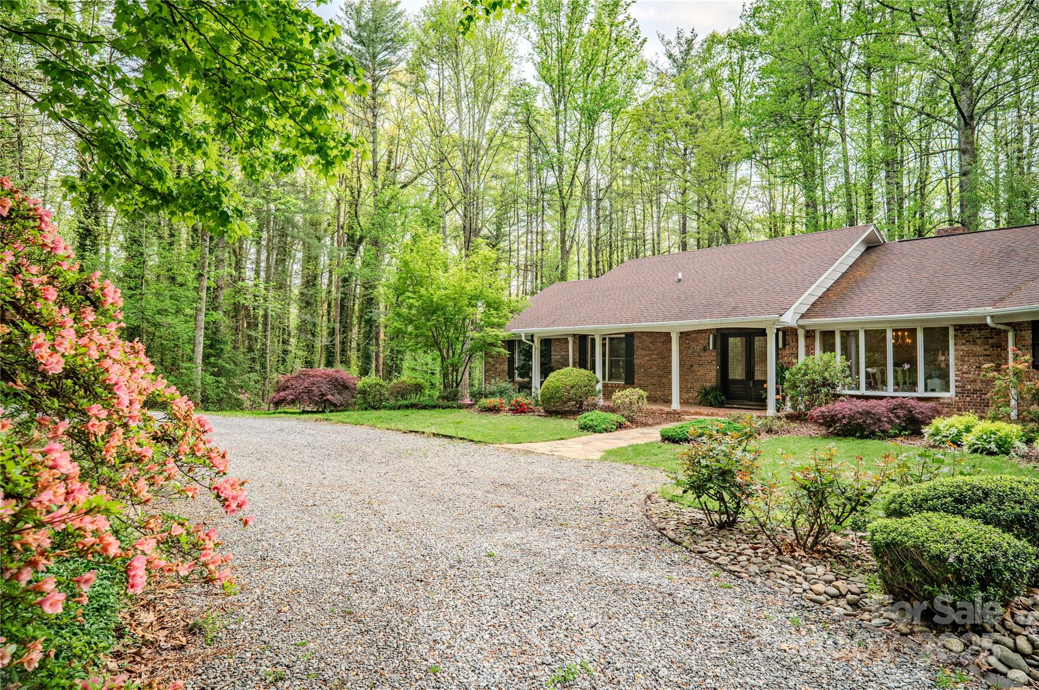 290 Tranquility Place Hendersonville, NC 28739 - Photo 4 of 48 a view of a house with a yard and potted plants