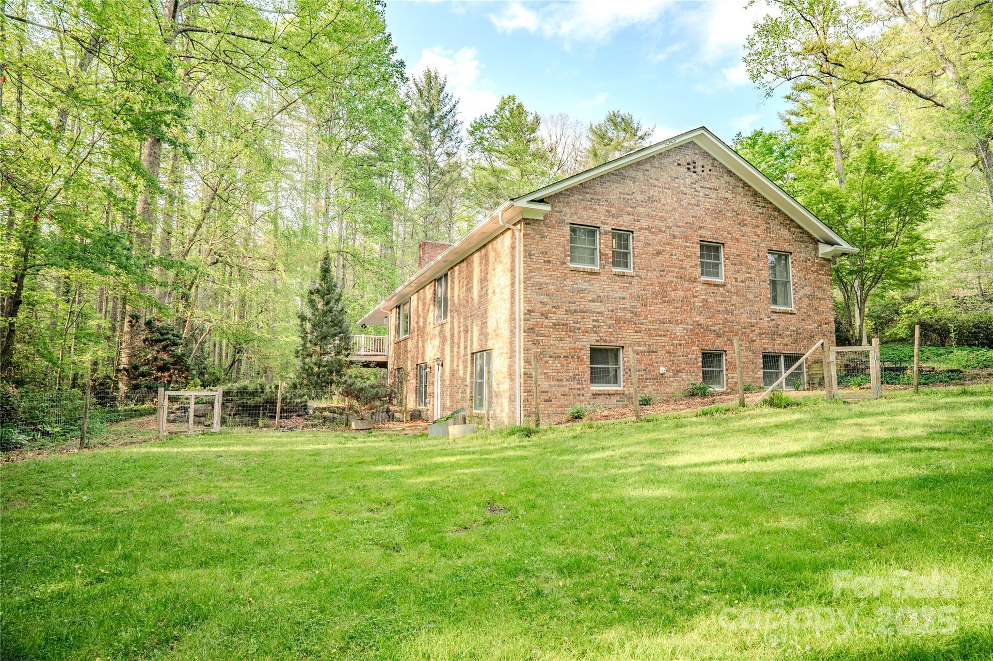290 Tranquility Place Hendersonville, NC 28739 - Photo 45 of 48 a view of a house with a yard