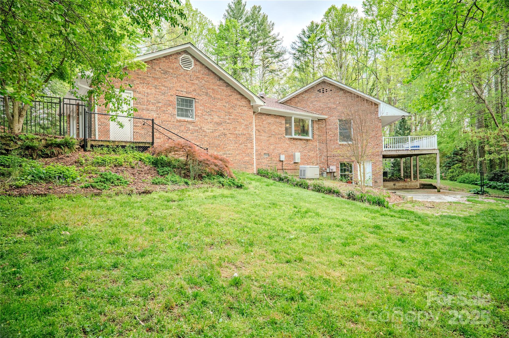 290 Tranquility Place Hendersonville, NC 28739 - Photo 47 of 48 a view of a yard in front of a house with large trees