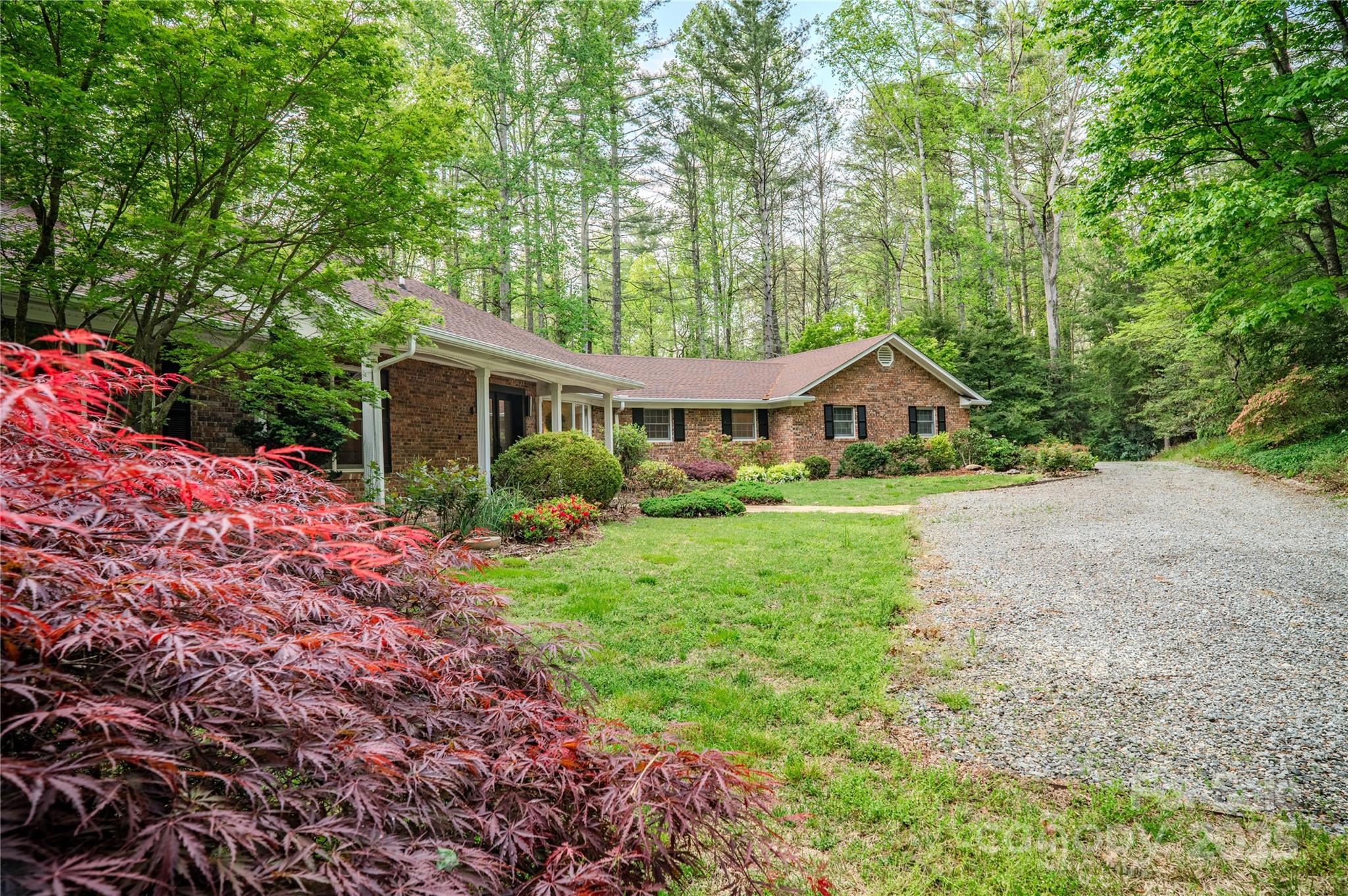 290 Tranquility Place Hendersonville, NC 28739 - Photo 5 of 48 a front view of a house with yard and green space