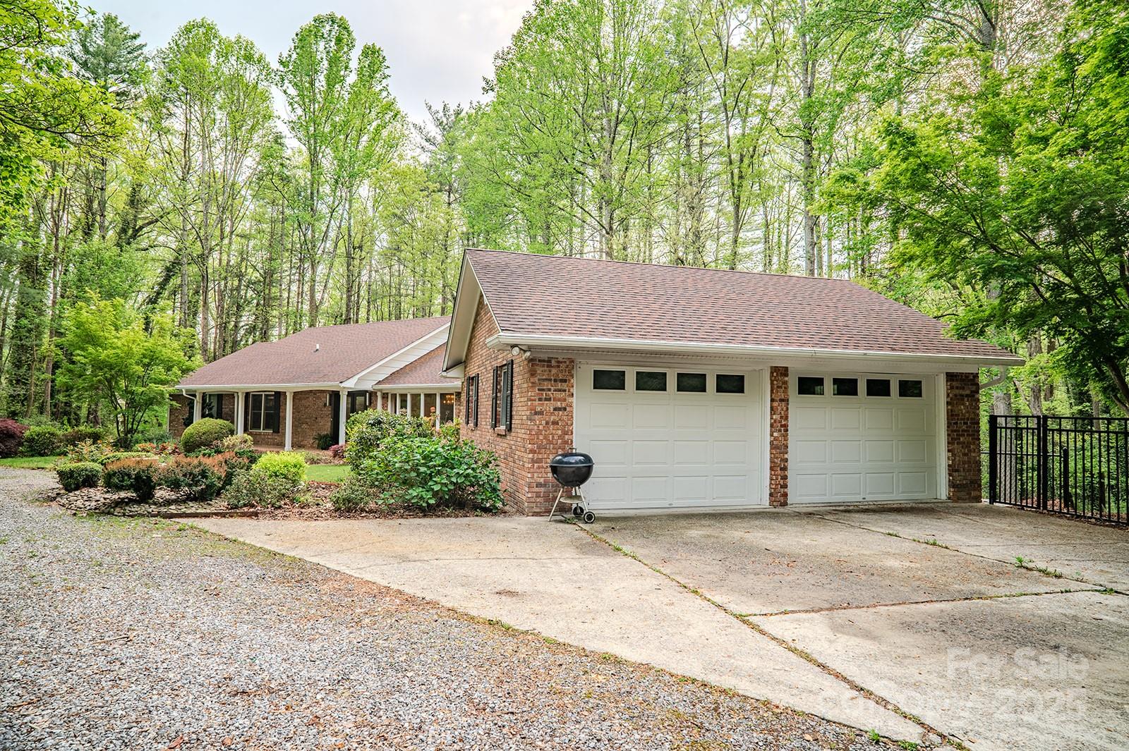 290 Tranquility Place Hendersonville, NC 28739 - Photo 6 of 48 a front view of a house with a garden