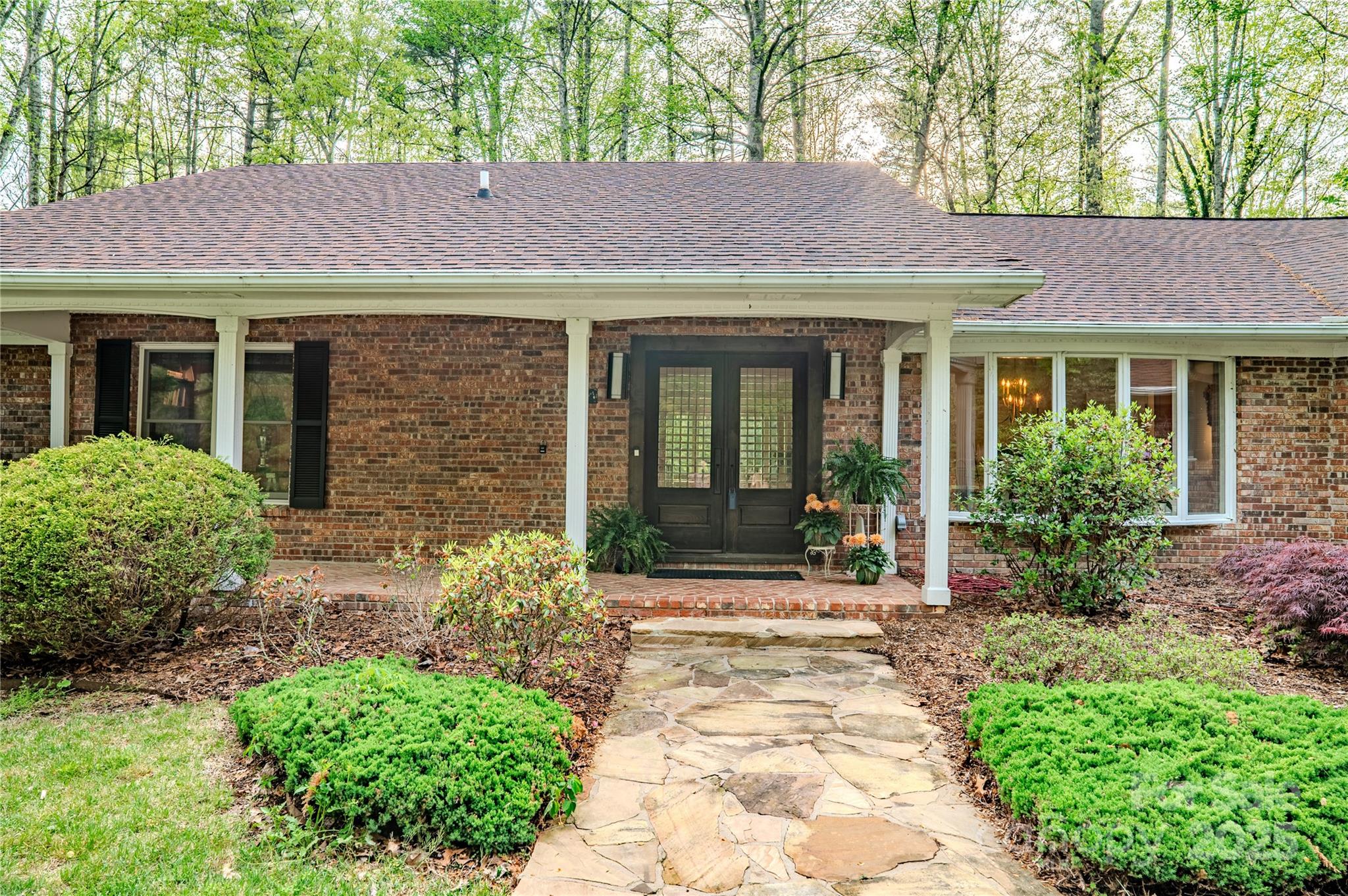 290 Tranquility Place Hendersonville, NC 28739 - Photo 7 of 48 a front view of a house with garden