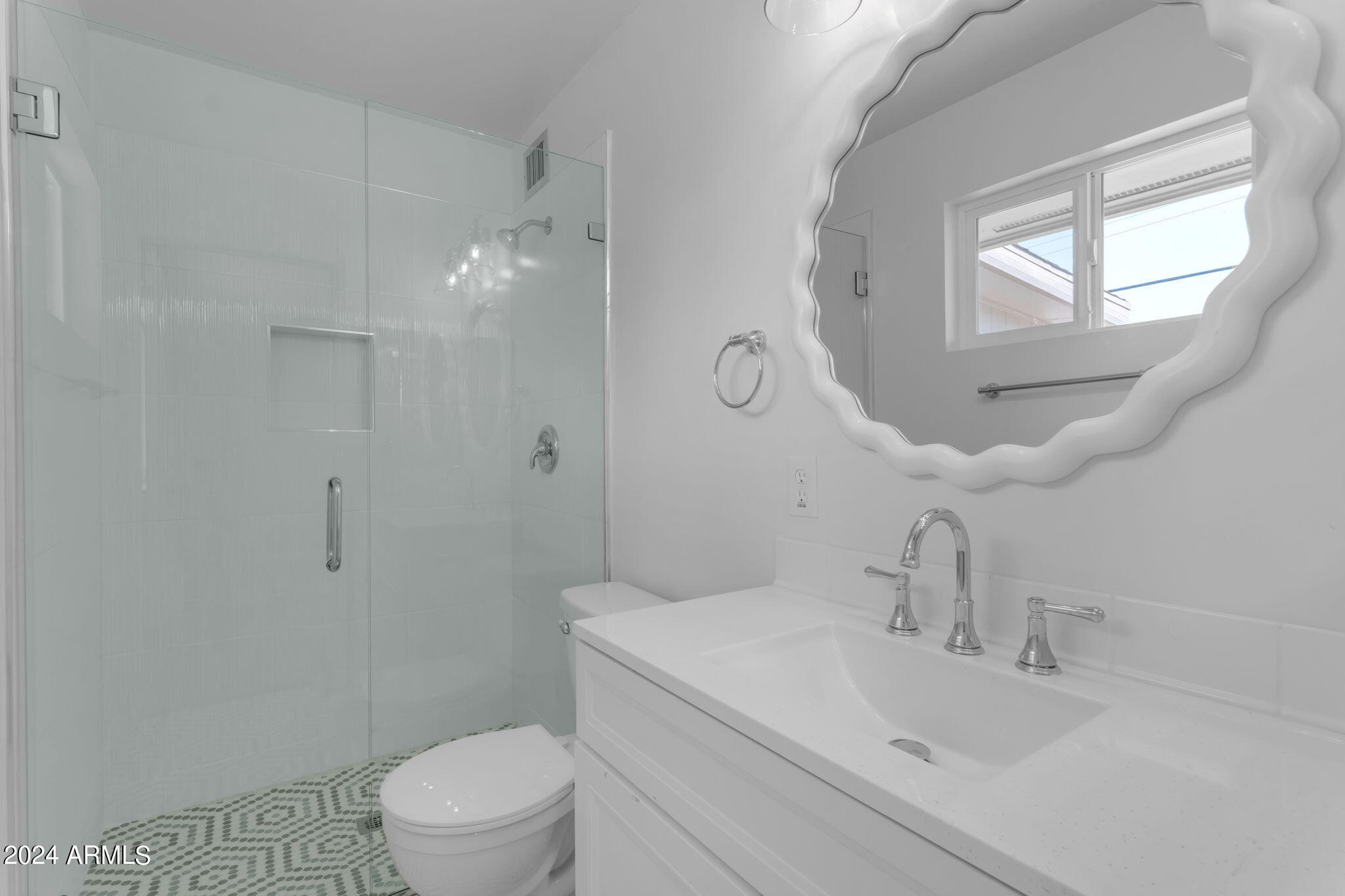 5643 Covina Road Mesa, AZ 85205 - Photo 4 of 12 a bathroom with a sink a toilet and a mirror
