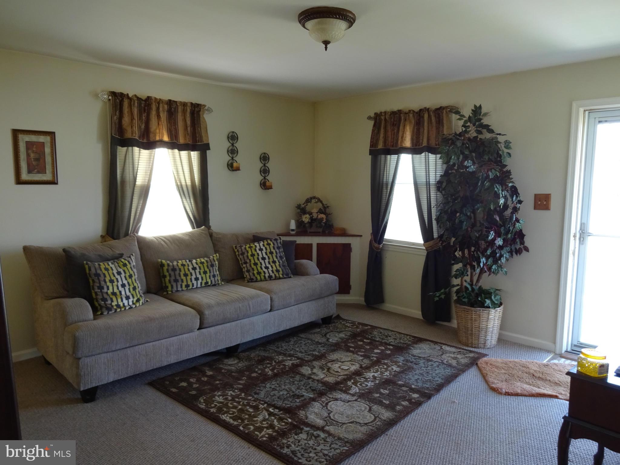 911 Woodlynn Road Baltimore, MD 21221 - Photo 3 of 10 a living room with furniture and a window