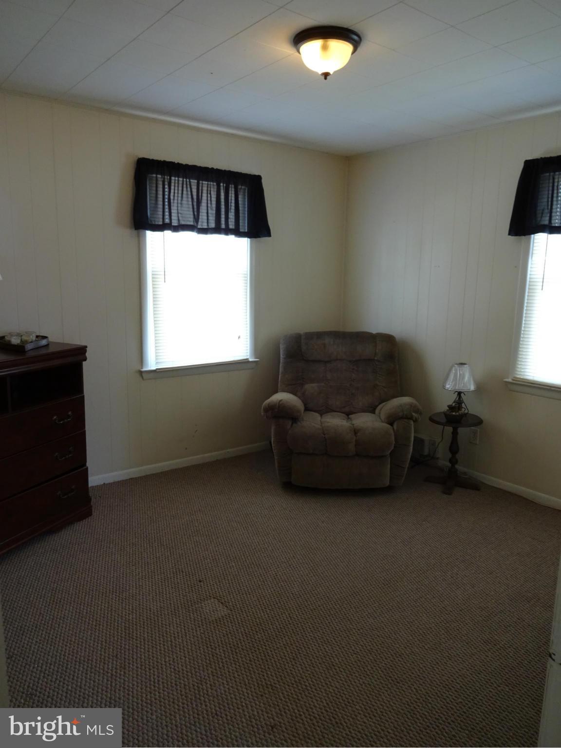 911 Woodlynn Road Baltimore, MD 21221 - Photo 7 of 10 a living room with furniture a window and a flat screen tv