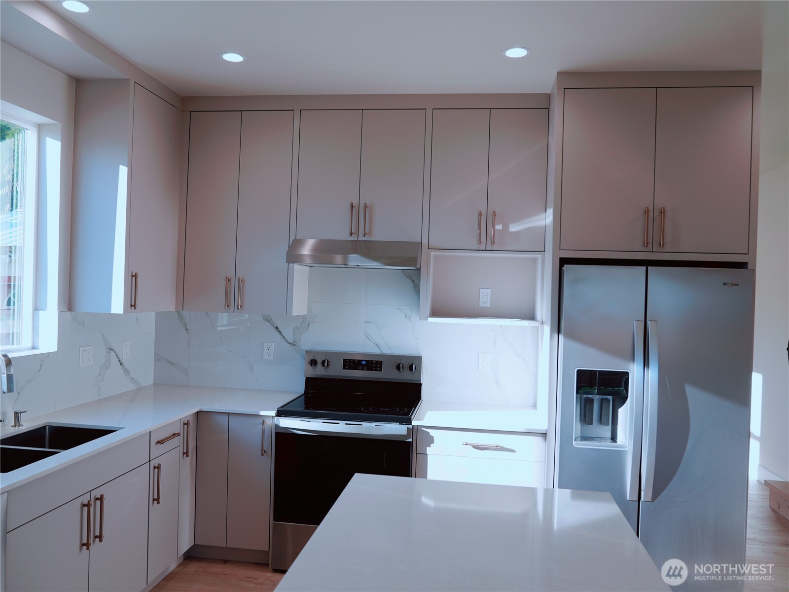 2155 Siddle Loop, Unit 106 Ferndale, WA 98248 - Photo 12 of 12 a kitchen with stainless steel appliances white cabinets and a refrigerator