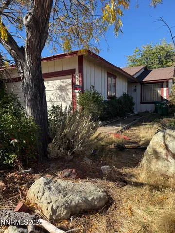 a view of a house with a yard covered with snow in the background