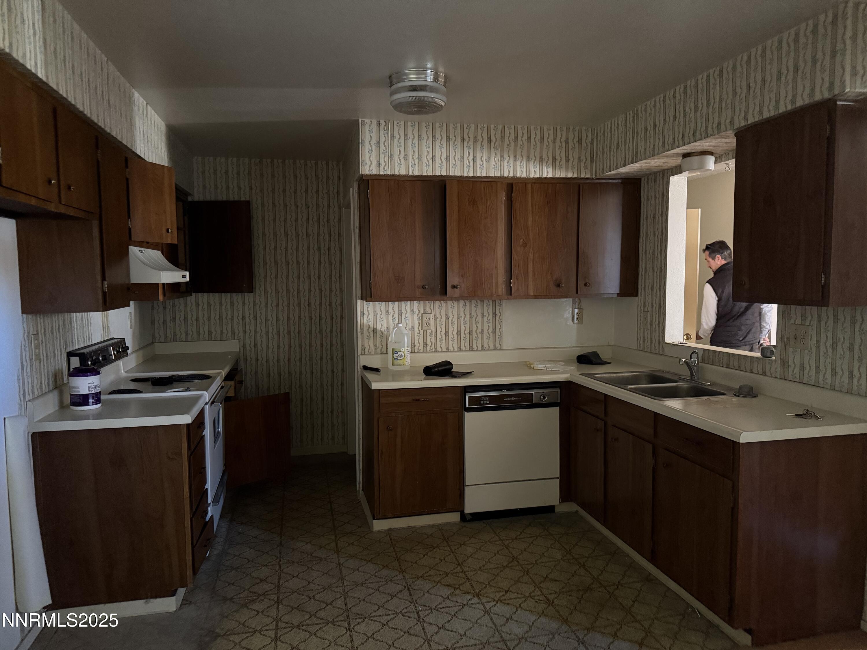 6521 Flower Street Reno, NV 89506 - Photo 3 of 9 a kitchen with stainless steel appliances granite countertop a stove top oven a sink dishwasher and a refrigerator