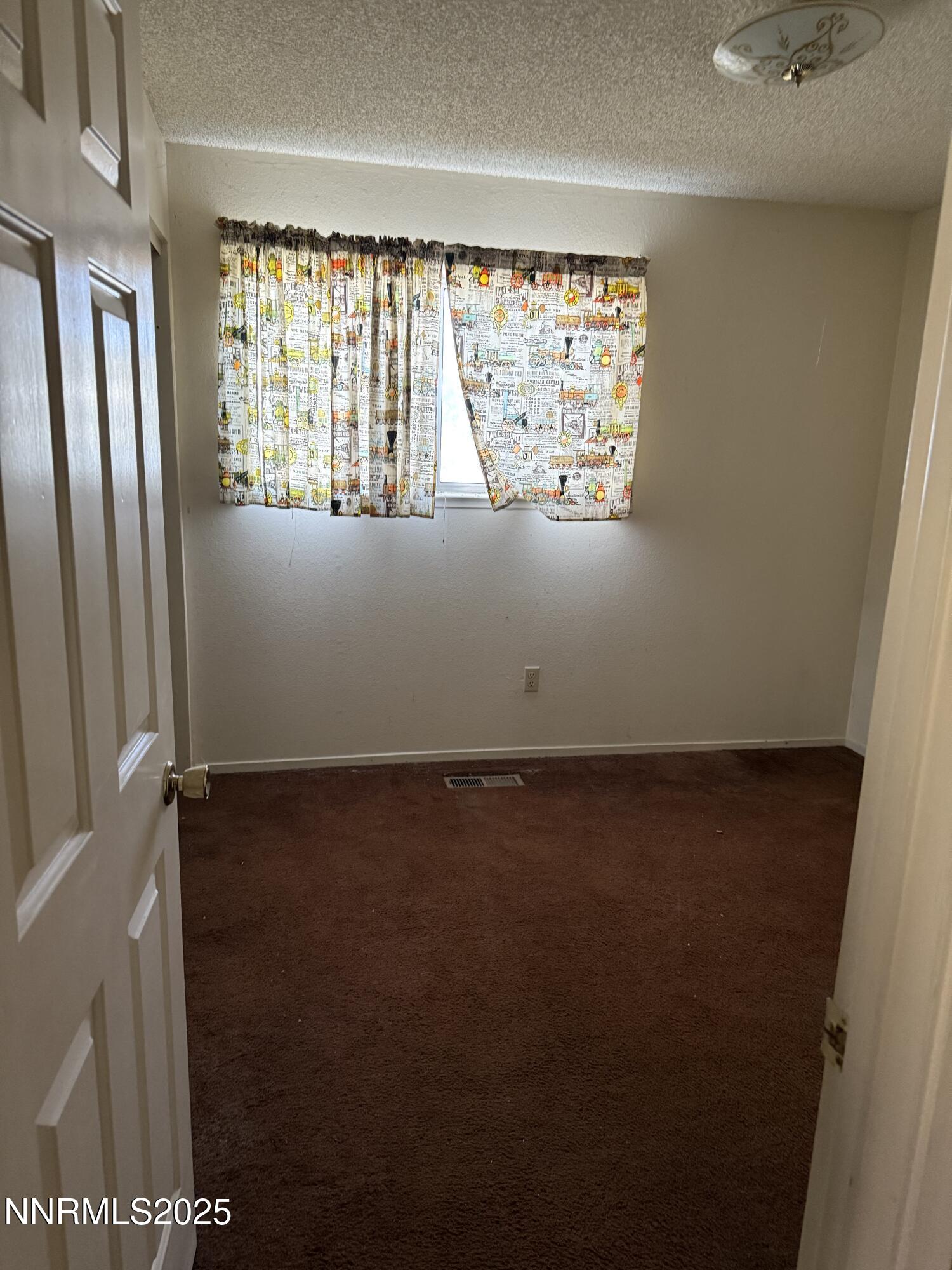 6521 Flower Street Reno, NV 89506 - Photo 8 of 9 a view of an empty room with a window