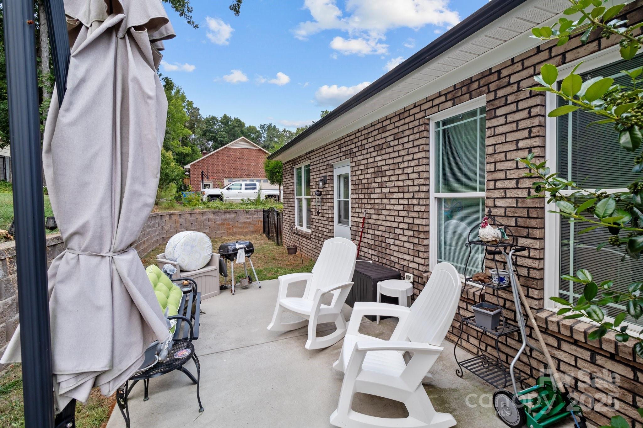 203 Poplins Grove Church Road Albemarle, NC 28001 - Photo 15 of 48 a view of backyard with outdoor seating and plants